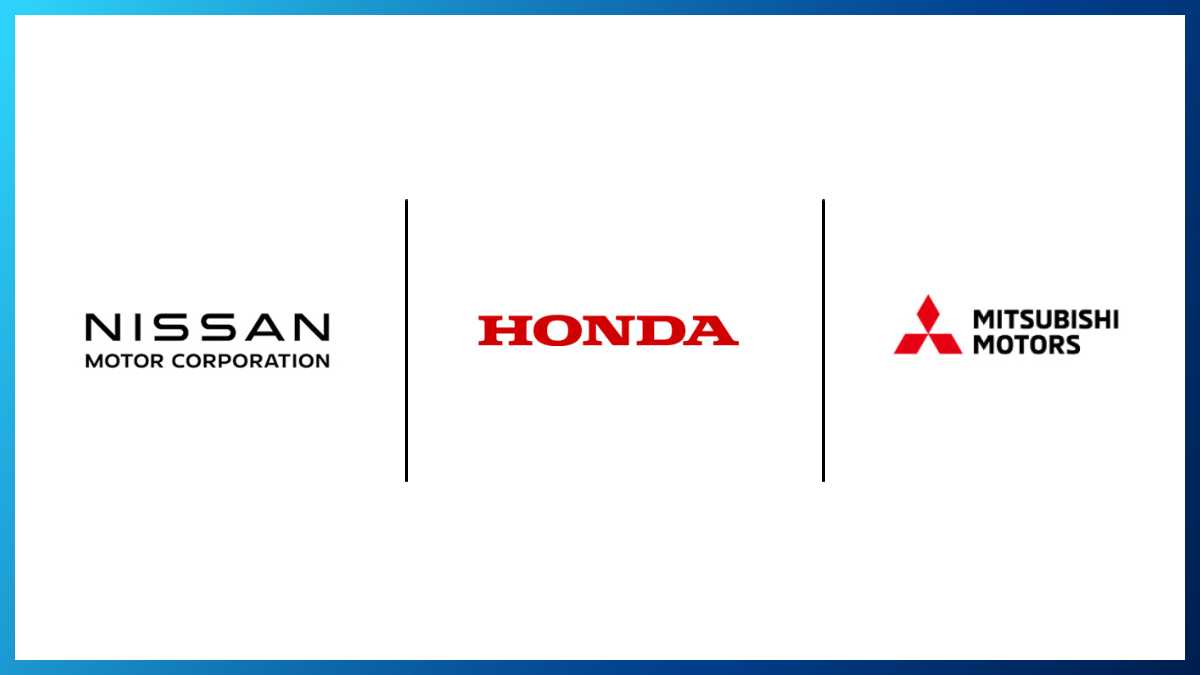 Executives from Honda, Nissan, and Mitsubishi signing a memorandum of understanding for a historic merger